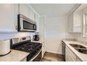 Modern kitchen with stainless steel appliances, white cabinets, and granite countertops at 1146 Croke Dr, Thornton, CO 80260