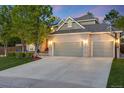 Charming brick home boasts a spacious three-car garage and beautifully landscaped front yard at 10188 Stephen Pl, Highlands Ranch, CO 80130