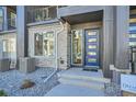 Townhome entrance with blue door and brick facade at 16559 Peak Way, Broomfield, CO 80023