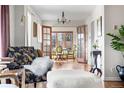 Stylish living room with hardwood floors, French doors, and plenty of natural light at 3308 S Birch St, Denver, CO 80222