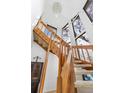 Well-lit staircase with carpet and wood railing leads to the upper level of home at 3308 S Birch St, Denver, CO 80222