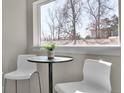 Bright breakfast nook area with table and chairs, offering a pleasant view at 2140 S Ash St # 102, Denver, CO 80222