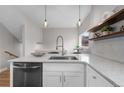 Bright kitchen island with stainless steel appliances, granite countertops, and modern lighting at 2140 S Ash St # 102, Denver, CO 80222