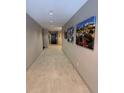 Apartment hallway featuring neutral colored walls and flooring with mountain artwork at 1062 Rockhurst Dr # 302, Highlands Ranch, CO 80129