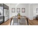 This dining room showcases a table set for four adjacent to a modern kitchen at 7812 W 43Rd Pl, Wheat Ridge, CO 80033