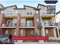 Modern townhome with brick accents, balconies, and contemporary design elements at 7812 W 43Rd Pl, Wheat Ridge, CO 80033