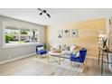 Bright living room with large windows and comfortable seating arrangement at 3940 S Hazel Ct, Englewood, CO 80110