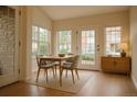 Bright dining area with large windows, hardwood floors, and modern furnishings creating an inviting space at 2980 W Centennial Dr # L, Littleton, CO 80123