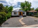 Charming home featuring solar panels, gravel landscaping, and a welcoming front entrance at 3636 Ames St, Wheat Ridge, CO 80212