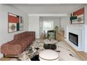 Spacious living room featuring hardwood floors, fireplace and large windows at 10825 Brewer Dr, Northglenn, CO 80234