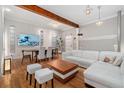 Open living room featuring hardwood floors, exposed beams, and bright natural lighting at 720 Lipan St, Denver, CO 80204