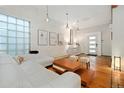 Bright living room boasts natural light, hardwood floors and modern white furniture at 720 Lipan St, Denver, CO 80204