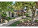 Charming condo exterior with brick accents, green landscaping, and inviting walkways at 6495 E Happy Canyon Rd # 114, Denver, CO 80237