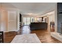 Open living area with hardwood floors and fireplace at 9303 W 66Th Pl, Arvada, CO 80004