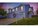 Beautiful two-story townhome showcasing a tidy lawn, neutral siding, and a welcoming front entrance at 11120 Josephine Way, Northglenn, CO 80233