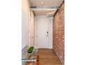 Welcoming entryway featuring a brick accent wall and modern decor at 1720 Wynkoop St # Ph403, Denver, CO 80202