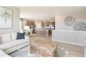 Open-concept living room and kitchen featuring modern decor, stainless steel appliances, and hardwood floors at 4621 Cattle Cross Trl, Castle Rock, CO 80104