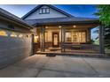 Inviting front porch with craftsman columns and front door with decorative glass at 15333 Heritage Cir, Thornton, CO 80602