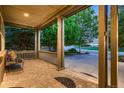 Covered front porch provides shade and seating area, with brick and railing at 15333 Heritage Cir, Thornton, CO 80602