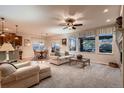 Open-concept living and dining area with fireplace and large windows for natural light at 15333 Heritage Cir, Thornton, CO 80602