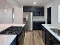 Spacious kitchen with stainless steel appliances, a gas cooktop, and ample counter space at 1455 S Tennyson St, Denver, CO 80219