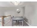 Charming dining area with modern light fixture and stairway to the left at 2268 S Laredo St, Aurora, CO 80013