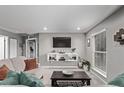 Comfortable living room with floating shelves, a TV, and natural light at 2268 S Laredo St, Aurora, CO 80013