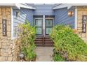 Close-up of townhome entrances with stone accents and manicured landscaping at 8312 S Saulsbury St # C, Littleton, CO 80128