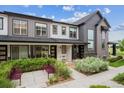 Inviting exterior view of a modern townhome with a landscaped entrance and walkway at 9269 Garnett St # C, Arvada, CO 80007