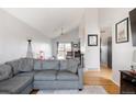 Open-concept living room with views to the adjacent dining area, hardwood floors, and modern furniture. The perfect space for gatherings at 2664 S Grant St, Denver, CO 80210