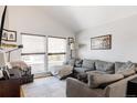 Bright living room featuring a large gray sectional sofa, natural light, and neutral decor. Ready for relaxation and comfort at 2664 S Grant St, Denver, CO 80210