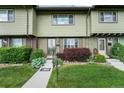 Charming townhome featuring a manicured lawn, brick accents, and a welcoming front entrance at 628 S Carr St, Lakewood, CO 80226