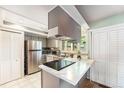 Well-lit kitchen boasts stainless steel appliances, ample counter space, and stylish shutters at 628 S Carr St, Lakewood, CO 80226