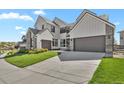 Wide driveway leading to an attached two-car garage, providing ample parking space for residents and guests at 2230 Rim Ridge Dr, Castle Pines, CO 80108