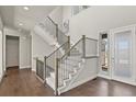 Bright entryway with hardwood floors, staircase, and stylish railing design at 2230 Rim Ridge Dr, Castle Pines, CO 80108