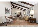 Bright living room with vaulted ceilings and exposed beams, offering a spacious feel at 3752 S Rosemary Way, Denver, CO 80237