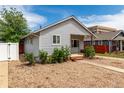 Charming single-story home with mature landscaping, gravel front yard, and inviting walkway at 436 S 4Th Ave, Brighton, CO 80601