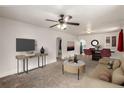 Bright living room features modern decor, carpeted floors, and a ceiling fan at 436 S 4Th Ave, Brighton, CO 80601