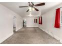 Spacious living room with neutral carpet, ceiling fan, and archway leading to other rooms at 436 S 4Th Ave, Brighton, CO 80601