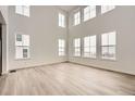 Spacious living room with a soaring ceiling and an abundance of natural light from numerous windows at 39440 Congress Ln, Elizabeth, CO 80107