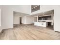 Open-concept living space featuring light wood floors, high ceilings, and a modern kitchen at 39440 Congress Ln, Elizabeth, CO 80107