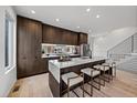 Contemporary kitchen featuring dark wood cabinets and a large island at 5098 E Donald, Denver, CO 80222