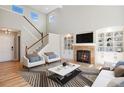 Bright living room featuring a fireplace, built-in shelving, and large windows providing ample natural light at 777 Whispering Oak Dr, Castle Rock, CO 80104