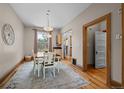 Charming dining room featuring hardwood floors, a stylish light fixture, and a view to the kitchen, perfect for gatherings at 14 S Lincoln St # 16, Denver, CO 80209