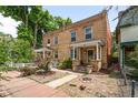 Classic brick home with a welcoming front porch, landscaped yard, and charming curb appeal in a desirable neighborhood at 14 S Lincoln St # 16, Denver, CO 80209