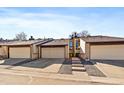 Townhome exterior with driveways, garages, and well-maintained landscaping at 1161 S Marshall St, Lakewood, CO 80232