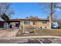 Street view of a well-maintained one-story brick home with a covered carport and small front yard at 4133 S Kalamath Ct, Englewood, CO 80110