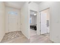 Bright entryway with wood floors, a closet and views of the bedroom and bathroom at 646 Gamble Oak St, Brighton, CO 80601