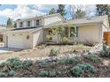 Inviting home exterior with light brick, tasteful landscaping, and a cozy covered entry at 14582 E Harvard Ave, Aurora, CO 80014