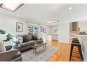 Bright living room featuring hardwood floors, a comfortable sofa, and stylish decor at 14582 E Harvard Ave, Aurora, CO 80014